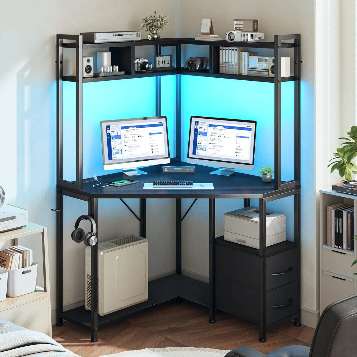 Corner gaming desk includes outlets, LED lights, drawers, shelves, hooks.