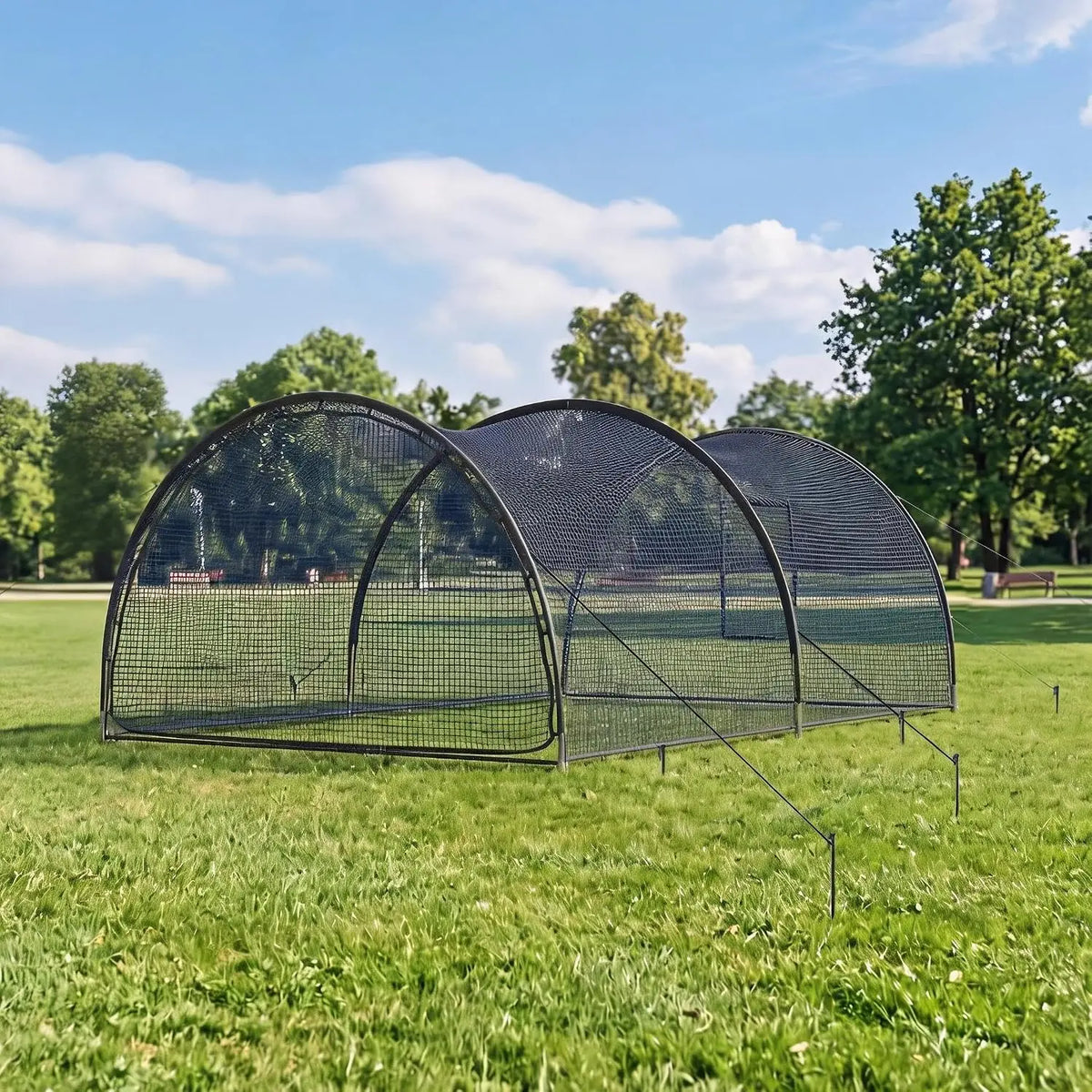 Portable batting cage includes pitching machine hole and detachable door.