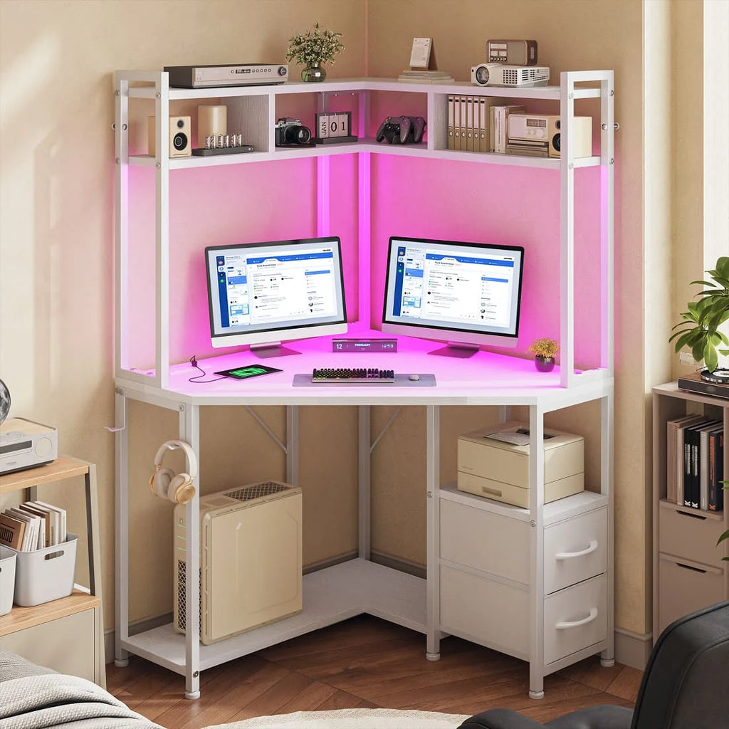 Corner gaming desk includes outlets, LED lights, drawers, shelves, hooks.