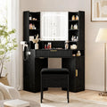 Corner vanity features a lighted mirror, glass top, charging station, and drawers.